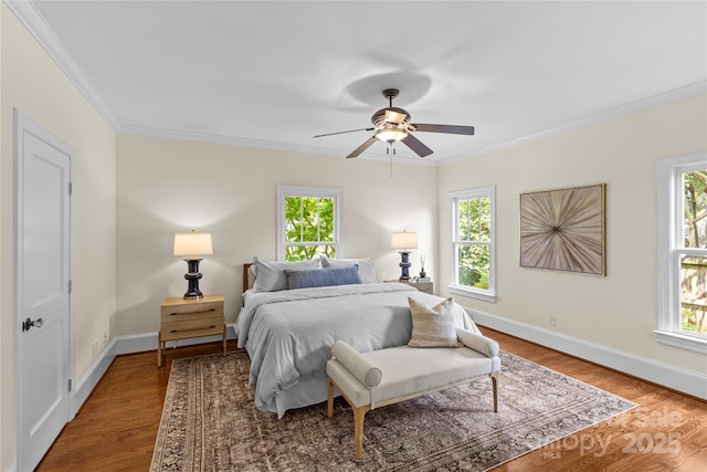 1500 Lynway Dr, Charlotte, NC 28203 - bedroom featuring multiple windows, crown molding, wood finished floors, and baseboards