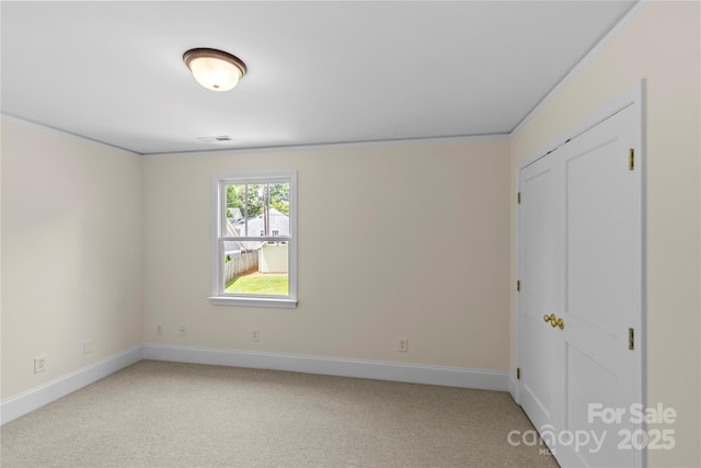 1500 Lynway Dr, Charlotte, NC 28203 - unfurnished bedroom with light carpet, baseboards, and a closet