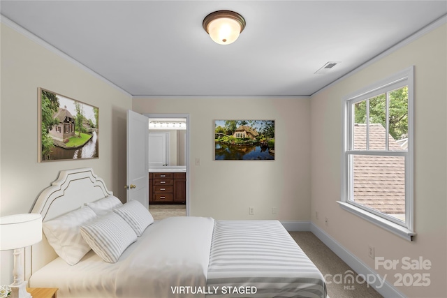 1500 Lynway Dr, Charlotte, NC 28203 - bedroom with baseboards, connected bathroom, and light colored carpet