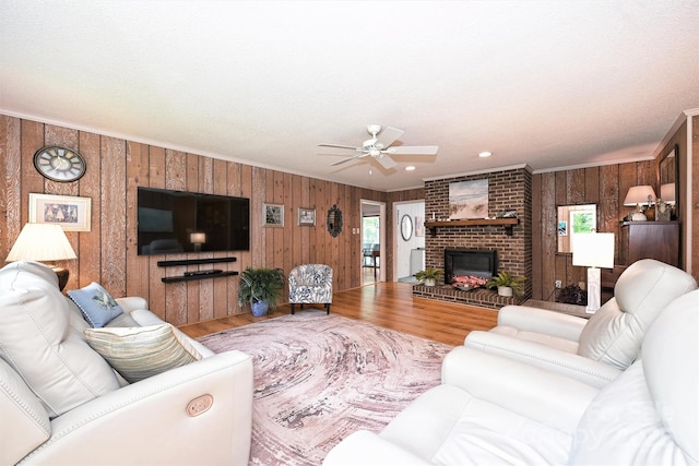 3017 Brooks Mill Ln, Wingate, NC 28174 - living room with wooden walls, wood finished floors, ceiling fan, plenty of natural light, and a fireplace