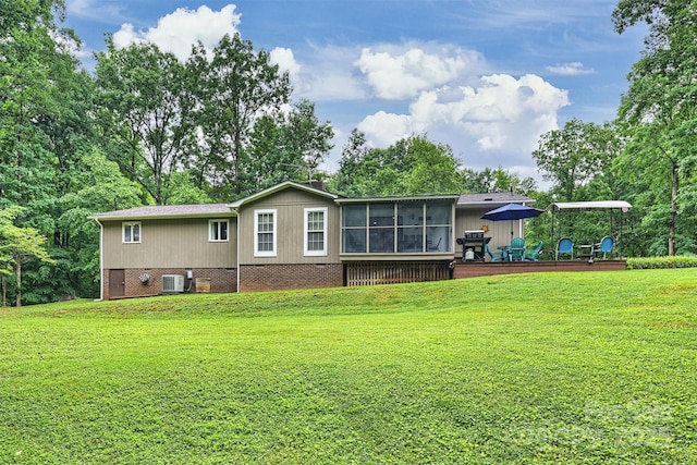 3017 Brooks Mill Ln, Wingate, NC 28174 - back of house with a sunroom, a lawn, central AC, a deck, and brick siding