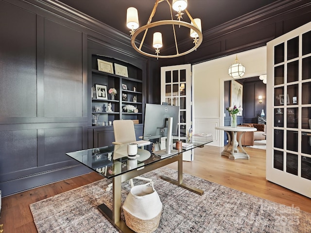 735 Davidson Run Ln, Davidson, NC 28036 - office area featuring a decorative wall, ornamental molding, a chandelier, built in features, and wood finished floors