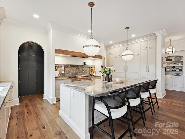 735 Davidson Run Ln, Davidson, NC 28036 - kitchen with crown molding, white cabinetry, light stone countertops, light wood-type flooring, and recessed lighting