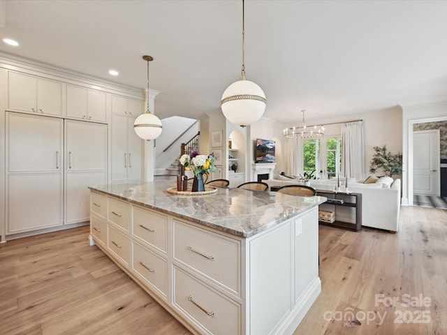 735 Davidson Run Ln, Davidson, NC 28036 - kitchen featuring light wood-style flooring, a kitchen island, open floor plan, pendant lighting, and recessed lighting