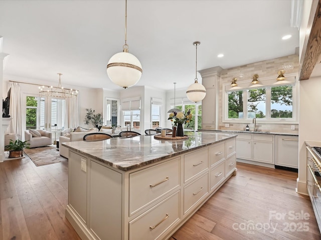 735 Davidson Run Ln, Davidson, NC 28036 - kitchen with plenty of natural light, a sink, a kitchen island, light wood-style flooring, and recessed lighting