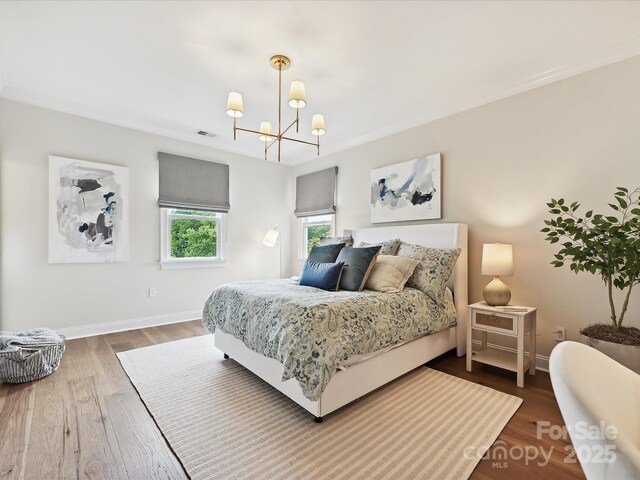 735 Davidson Run Ln, Davidson, NC 28036 - bedroom with a chandelier, wood finished floors, and baseboards
