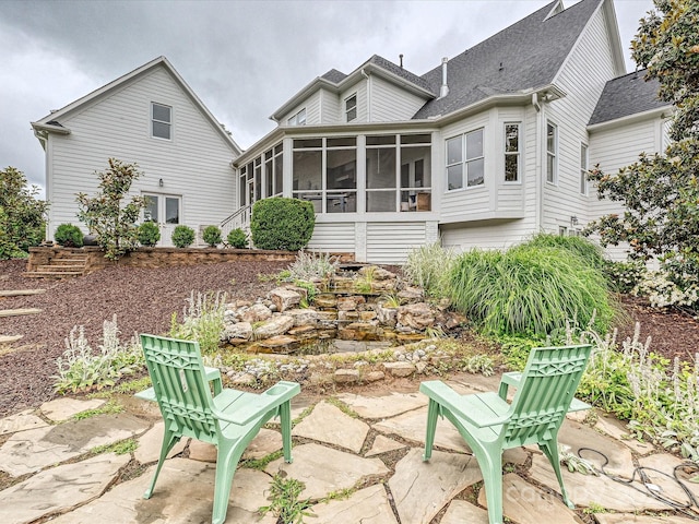 735 Davidson Run Ln, Davidson, NC 28036 - back of property featuring a sunroom, a patio, and a shingled roof