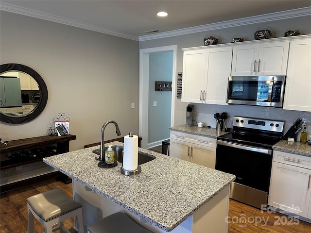 110 W Pine St, Lincolnton, NC 28092 - kitchen with appliances with stainless steel finishes, white cabinets, ornamental molding, decorative backsplash, and recessed lighting