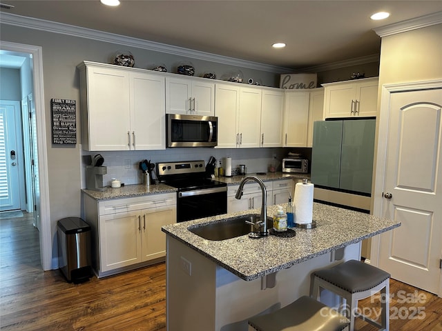 110 W Pine St, Lincolnton, NC 28092 - kitchen with stainless steel appliances, dark wood-style floors, white cabinets, ornamental molding, and backsplash