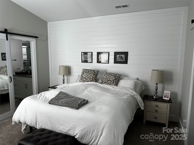 110 W Pine St, Lincolnton, NC 28092 - bedroom featuring a barn door and dark colored carpet
