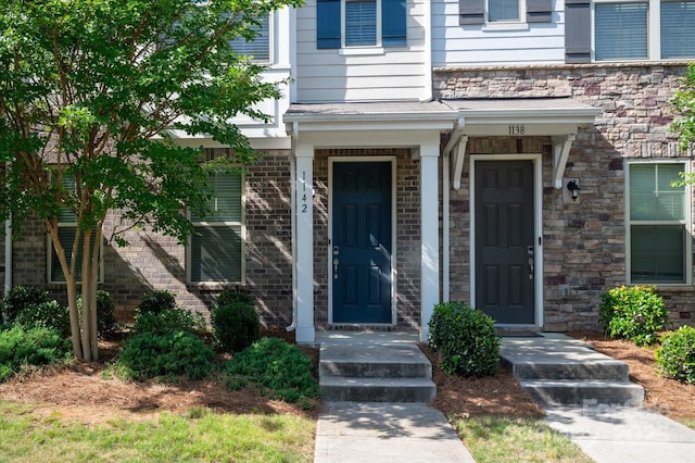 1142 Doveridge St, Charlotte, NC 28273 - view of exterior entry featuring stone siding and brick siding