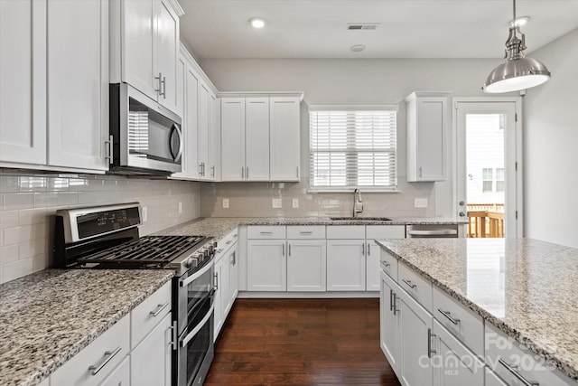 1142 Doveridge St, Charlotte, NC 28273 - kitchen with appliances with stainless steel finishes, a sink, white cabinetry, dark wood finished floors, and recessed lighting