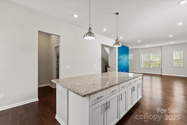 1142 Doveridge St, Charlotte, NC 28273 - kitchen with dark wood-style floors, a kitchen island, recessed lighting, white cabinets, and baseboards