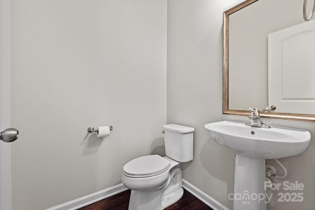 1142 Doveridge St, Charlotte, NC 28273 - bathroom featuring baseboards, toilet, and wood finished floors