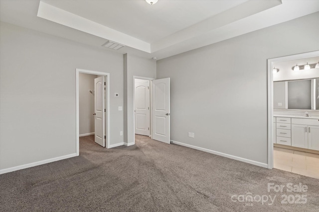1142 Doveridge St, Charlotte, NC 28273 - unfurnished bedroom featuring carpet flooring, a walk in closet, a tray ceiling, and ensuite bath