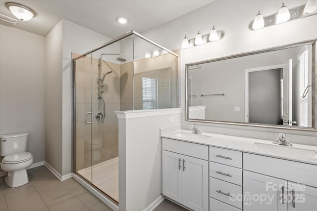1142 Doveridge St, Charlotte, NC 28273 - full bathroom featuring toilet, double vanity, a shower stall, baseboards, and tile patterned flooring