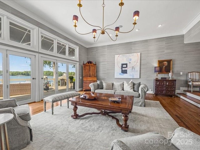 15 Old Stage Trl, Clover, SC 29710 - living room featuring wood finished floors, a chandelier, ornamental molding, a water view, and wallpapered walls