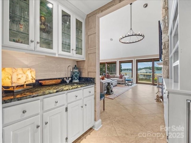 15 Old Stage Trl, Clover, SC 29710 - bar area with a chandelier, backsplash, a sink, light tile patterned flooring, and a towering ceiling