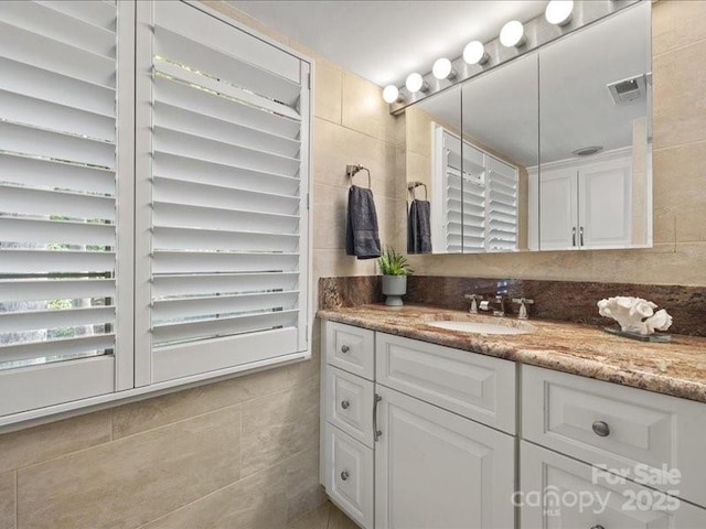 15 Old Stage Trl, Clover, SC 29710 - bathroom featuring tile walls, vanity, and tasteful backsplash