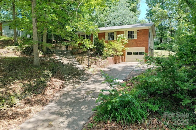 25 Evelake Dr, Asheville, NC 28806 - view of front of house with concrete driveway, an attached garage, and brick siding