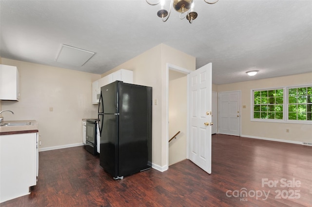 25 Evelake Dr, Asheville, NC 28806 - kitchen featuring black appliances, dark wood-style flooring, a sink, white cabinetry, and baseboards