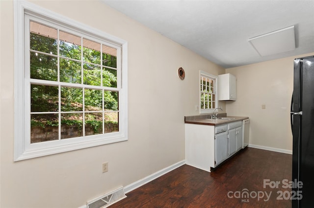 25 Evelake Dr, Asheville, NC 28806 - kitchen featuring freestanding refrigerator, white dishwasher, a sink, dark wood-style flooring, and healthy amount of natural light