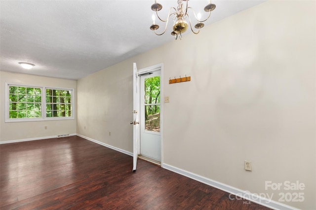25 Evelake Dr, Asheville, NC 28806 - spare room featuring a chandelier, baseboards, and dark wood-style floors