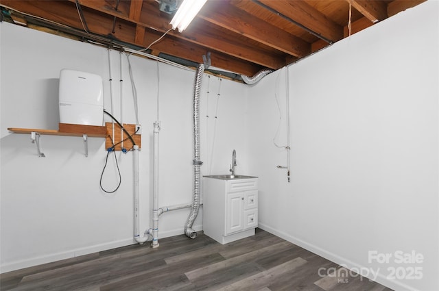 25 Evelake Dr, Asheville, NC 28806 - unfinished basement with dark wood finished floors, baseboards, and a sink
