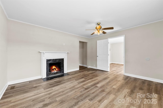 2009 Auten Rd, Gastonia, NC 28054 - unfurnished living room featuring wood finished floors, ceiling fan, a high end fireplace, baseboards, and crown molding