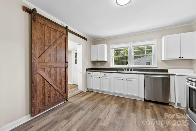 2009 Auten Rd, Gastonia, NC 28054 - kitchen featuring stainless steel appliances, a sink, a barn door, crown molding, and light wood-type flooring