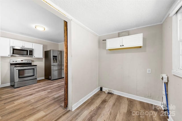 2009 Auten Rd, Gastonia, NC 28054 - washroom with light wood finished floors, crown molding, baseboards, and a textured ceiling