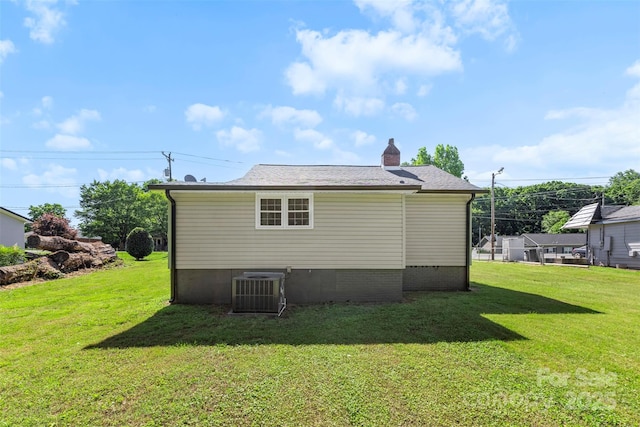2009 Auten Rd, Gastonia, NC 28054 - view of property exterior with a lawn, central AC, and a chimney