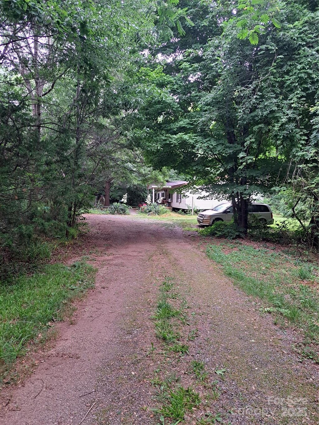 5023 Dogwood Ln, Stanley, NC 28164 - view of dirt / gravel road featuring a forest view