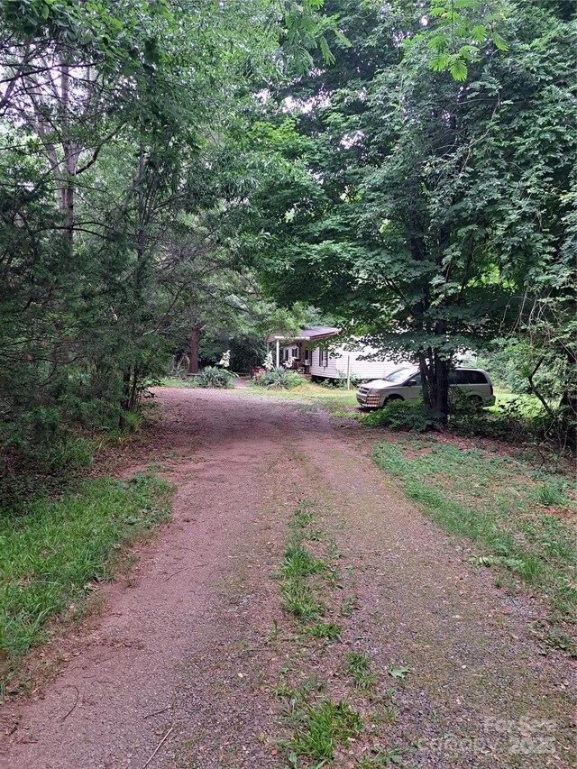 5023 Dogwood Ln, Stanley, NC 28164 - view of dirt / gravel road featuring a forest view