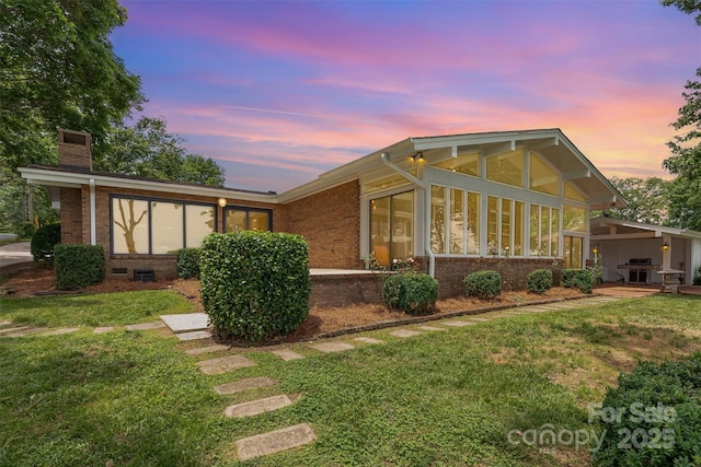5114 Leisure Ln, Sherrills Ford, NC 28673 - view of front of home featuring a sunroom, brick siding, a chimney, and a front yard