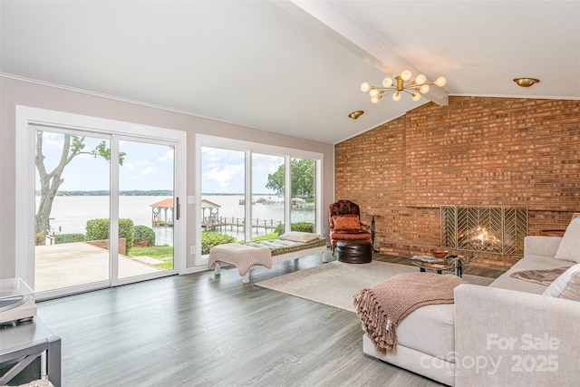 5114 Leisure Ln, Sherrills Ford, NC 28673 - living area featuring a chandelier, a water view, wood finished floors, brick wall, and a fireplace