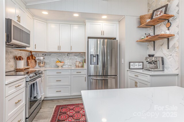 5114 Leisure Ln, Sherrills Ford, NC 28673 - kitchen featuring appliances with stainless steel finishes, light wood-style floors, white cabinets, tasteful backsplash, and open shelves