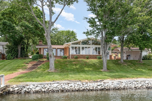 5114 Leisure Ln, Sherrills Ford, NC 28673 - view of front of house with brick siding, a front yard, a water view, and a chimney