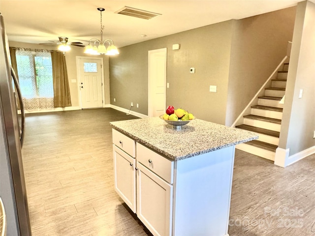 212 Old Centergrove Rd, Kannapolis, NC 28083 - kitchen featuring freestanding refrigerator, white cabinets, wood finished floors, and light stone counters
