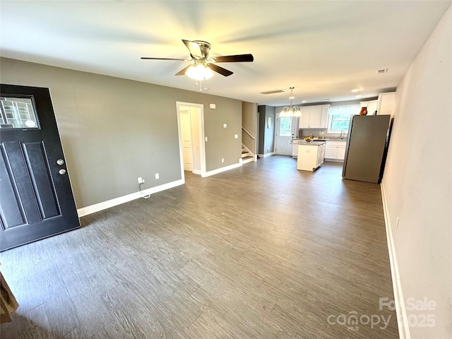 212 Old Centergrove Rd, Kannapolis, NC 28083 - unfurnished living room with stairs, dark wood finished floors, baseboards, and ceiling fan
