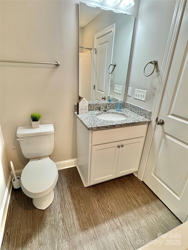 212 Old Centergrove Rd, Kannapolis, NC 28083 - full bathroom featuring baseboards, wood finished floors, vanity, and toilet