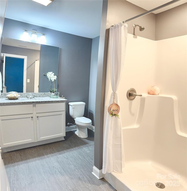 212 Old Centergrove Rd, Kannapolis, NC 28083 - bathroom with wood finished floors, vanity, toilet, a shower with curtain, and baseboards