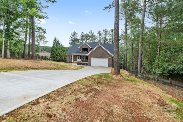 5025 Harbor View Dr E, Granite Falls, NC 28630 - view of front facade with driveway, brick siding, an attached garage, and a front yard