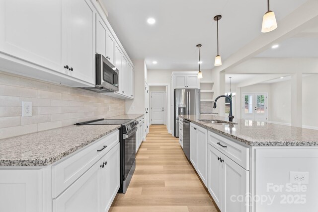 5025 Harbor View Dr E, Granite Falls, NC 28630 - kitchen with stainless steel appliances, a sink, an island with sink, backsplash, and light wood-type flooring