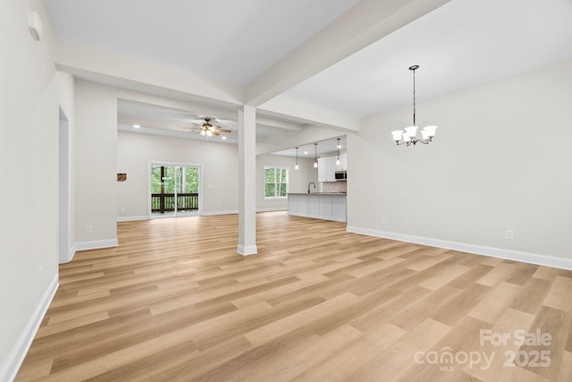 5025 Harbor View Dr E, Granite Falls, NC 28630 - unfurnished living room featuring a chandelier, light wood-style flooring, a ceiling fan, baseboards, and a sink