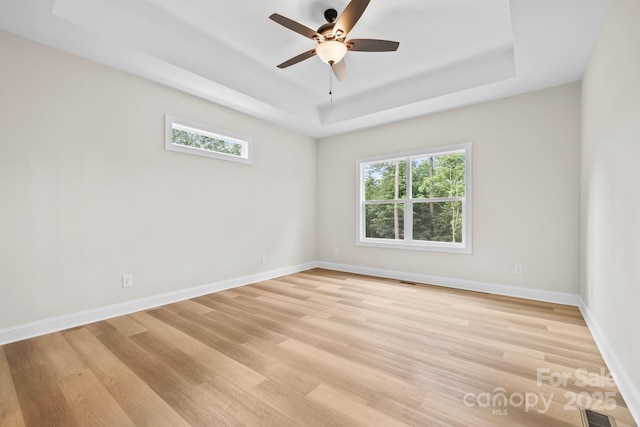 5025 Harbor View Dr E, Granite Falls, NC 28630 - unfurnished room with a tray ceiling, light wood-style floors, baseboards, and ceiling fan