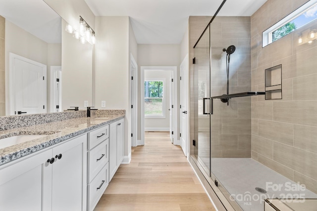5025 Harbor View Dr E, Granite Falls, NC 28630 - full bath with double vanity, a stall shower, healthy amount of natural light, and wood finished floors