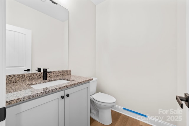 5025 Harbor View Dr E, Granite Falls, NC 28630 - bathroom featuring wood finished floors, vanity, toilet, and baseboards