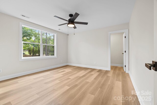 5025 Harbor View Dr E, Granite Falls, NC 28630 - empty room with light wood-style floors, a ceiling fan, and baseboards