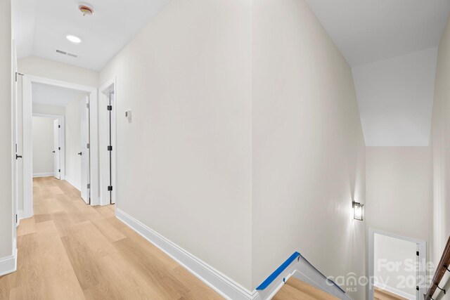 5025 Harbor View Dr E, Granite Falls, NC 28630 - hallway featuring light wood-style flooring, an upstairs landing, lofted ceiling, and baseboards